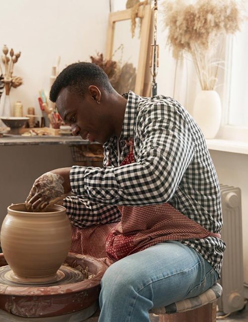 cheerful-man-working-on-new-clay-vessel-resize.jpg